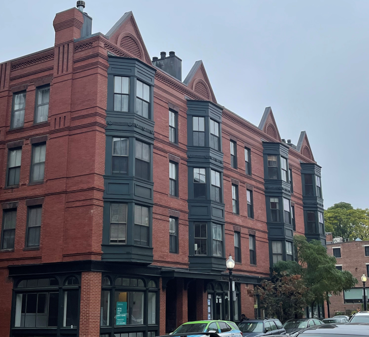 Older 4-story brick mixed-use building 